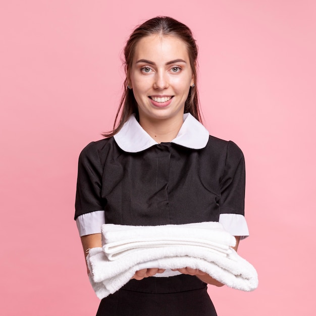 Free Photo Front View Happy Maid Holding White Towels