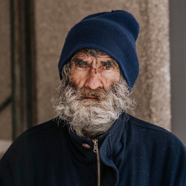 Free Photo | Front view of homeless man with a beard outdoors