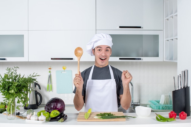 Free Photo | Front view joyful male chef in uniform holding wooden ...