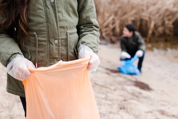 Free Photo | Front view of kids with plastic bag