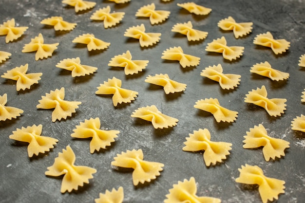 Free Photo Front View Little Raw Pasta Lined On Dark Grey Many Food Color Photo Meal Dough Italian Pasta