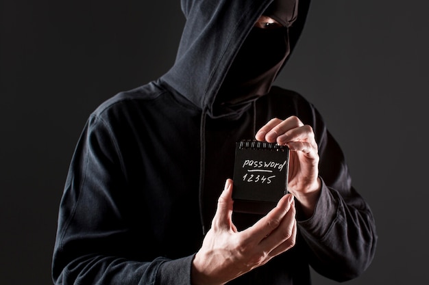 Free Photo | Front view of male hacker holding notebook with password