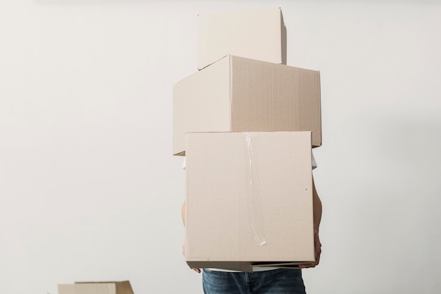 Download Free Photo | Front view man holding carton boxes