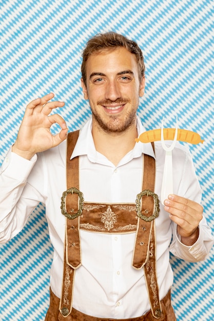 Free Photo | Front view of man holding sausage