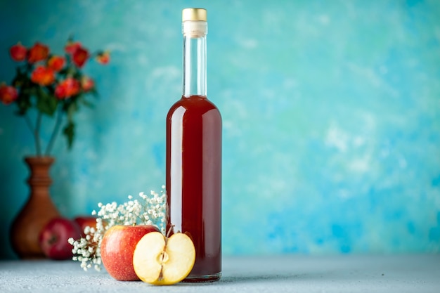 Front view red apple vinegar on blue background food fruit alcohol wine sour color juice Free Photo