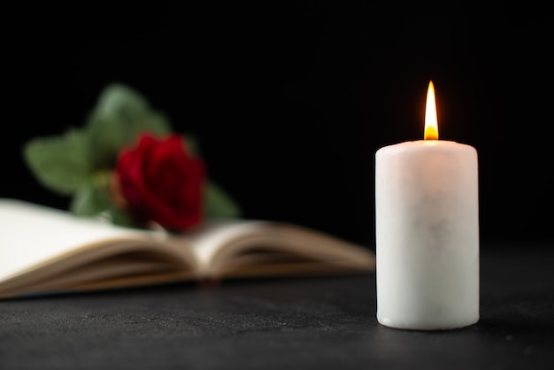 Free Photo | Front view of red rose with open book and candle on black