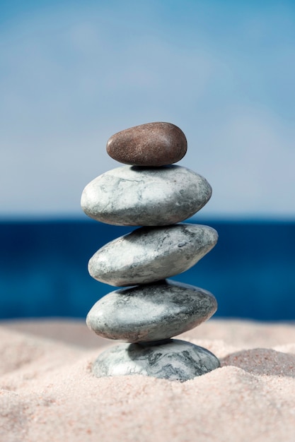 Free Photo | Front view of rocks stacked on beach sand