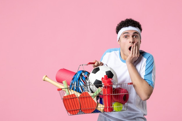 Front view shocked young male in sport clothes with basket full of sport things Free Photo