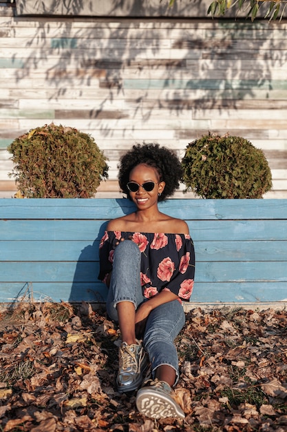 Free Photo | Front view smiley curly haired woman wearing sunglasses