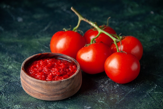 Front view tomato sauce with fresh red tomatoes on dark surface tomato red color seasoning pepper salt Free Photo