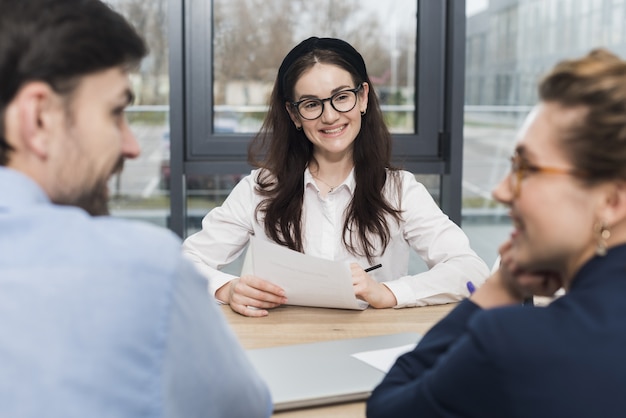 Front view of woman attending a job interview with human resources ...