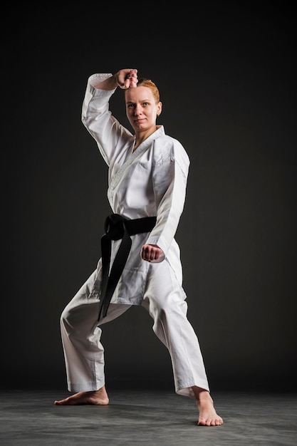 Free Photo | Front view woman doing karate pose