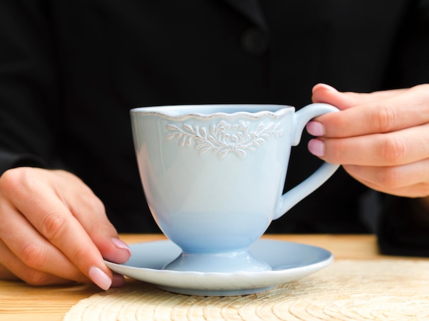 Free Photo | Front view woman holding blue teacup