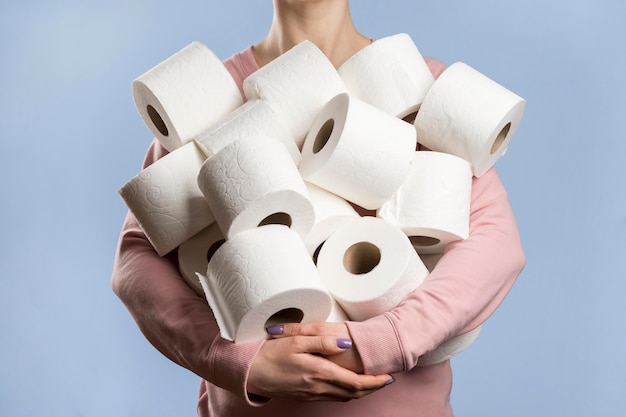 Free Photo Front View Of Woman Holding Too Many Toilet Paper Rolls
