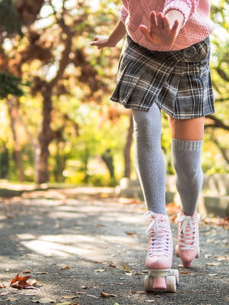 Download Front view of woman in skirt and socks roller skating ...