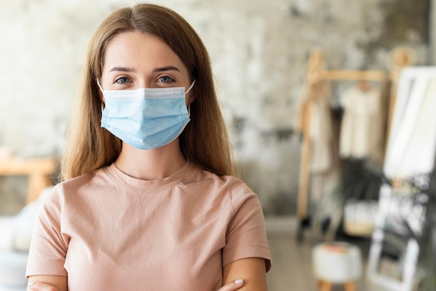 Front view of woman wearing medical mask with copy space Premium Photo