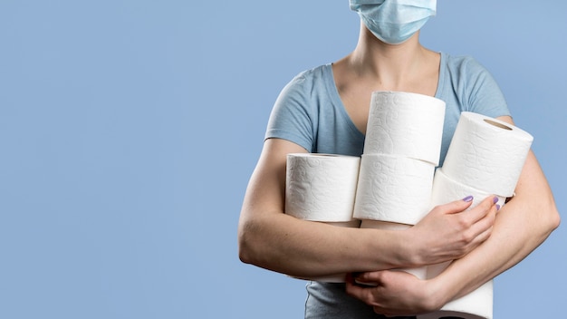 Premium Photo Front View Of Woman With Medical Mask Holding Multiple Toilet Paper Rolls