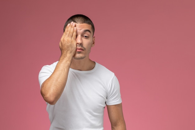 Free Photo | Front view young male in white t-shirt covering half of ...