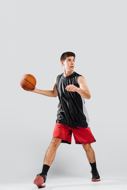 Download Premium Photo | Front view young man playing basketball