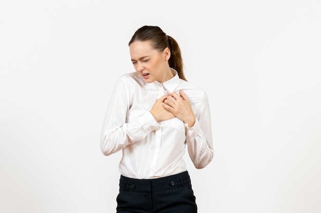 Front view young woman in white blouse having heart pain on white background office job female emotion feeling model Free Photo