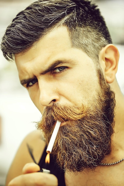 Premium Photo | Frown bearded man smoking cigarette