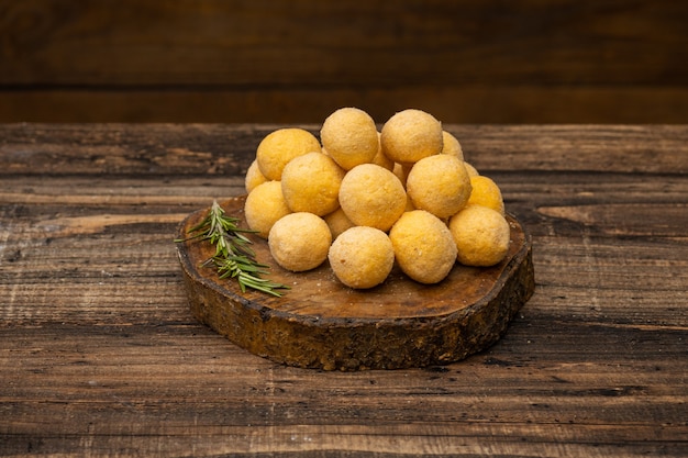 Premium Photo | Frozen cheese balls on wooden surface