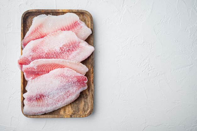 Premium Photo | Frozen, white fish fillet, on white table, top view