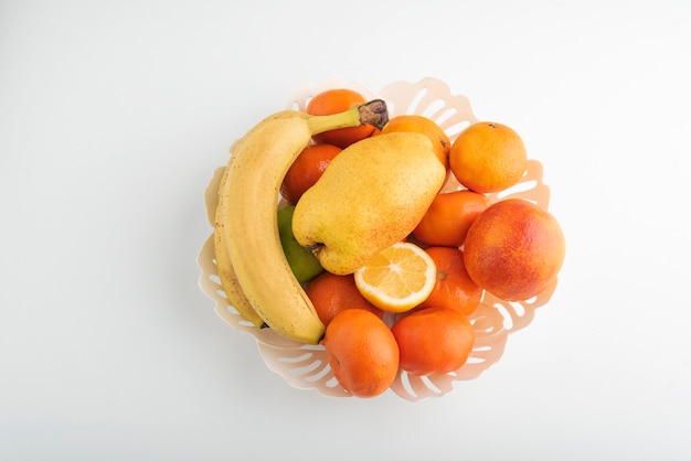 Premium Photo | Fruit bowl top view on white surface