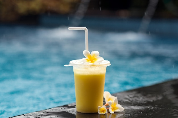 Fruit Coctail And Frangipani Flower Next To Poolside Premium Photo