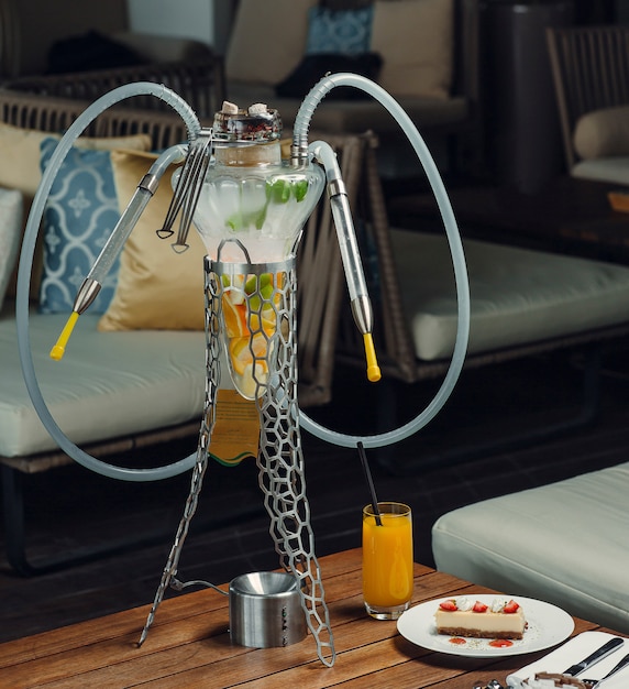 Free Photo | Fruit hookah tube with orange, apple, lemon in glass with