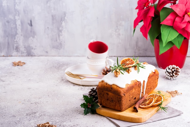 Premium Photo Fruit Loaf Cake Dusted With Icing Nuts And Dry Orange On Stone Christmas And Winter Holidays Homemade Cake