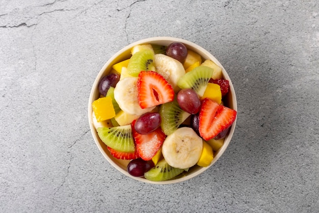 Premium Photo | Fruit salad in bowl on the table