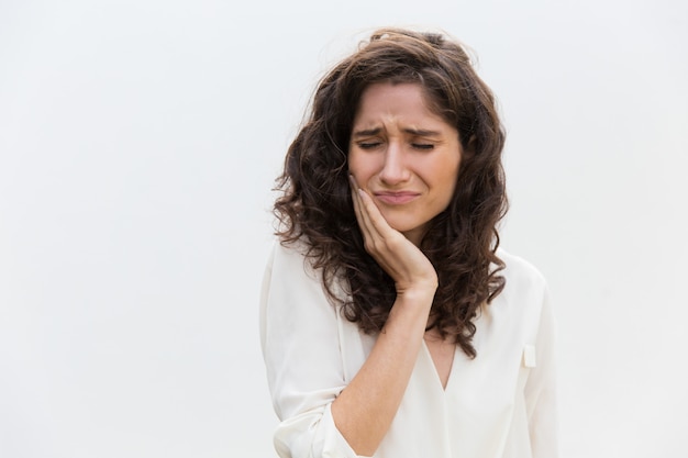 Frustrated unhappy woman suffering from toothache Free Photo