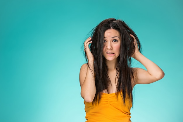 Frustrated young woman having a bad hair Free Photo