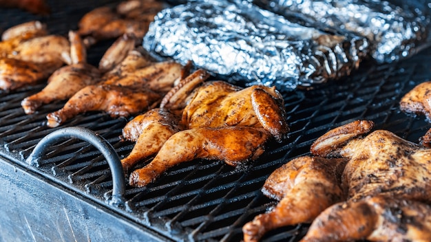 Premium Photo | Frying chickens on a grill. bbq. street food