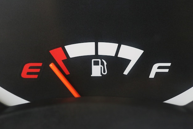 Fuel gauge with warning indicating low fuel tank. | Premium Photo