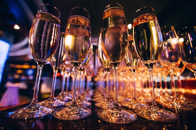 full-glass-of-champagne-in-a-nightclub-many-glasses-of-champagne-on-the-bar-bubbles-of-champagne-in-a-glass_215842-1081.jpg