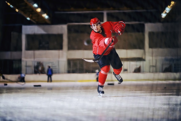 premium-photo-full-length-of-hockey-player-shooting-on-goal-in-ice-hall