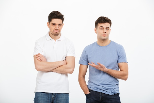 Premium Photo | Full length portrait of two disappointed young men