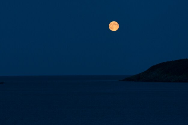 Premium Photo Full Moon Over The Ocean At Night Calvert Avalon Peninsula Newfoundland And Labrador Canada