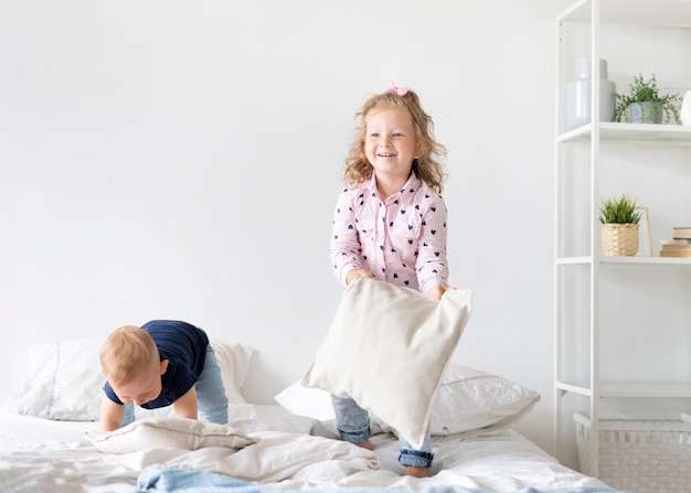 Free Photo | Full shot children playing with pillows