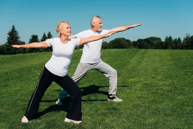 Full shot old people exercising outdoors Photo | Free Download