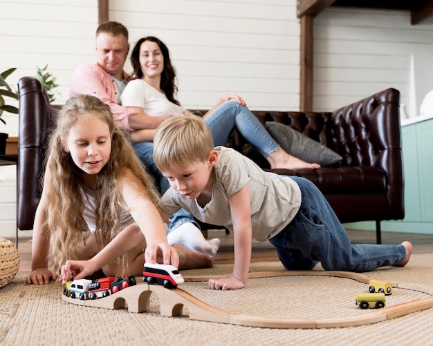 Premium Photo | Full shot parents watching kids play