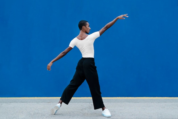 Free Photo | Full shot transgender dancing with blue background