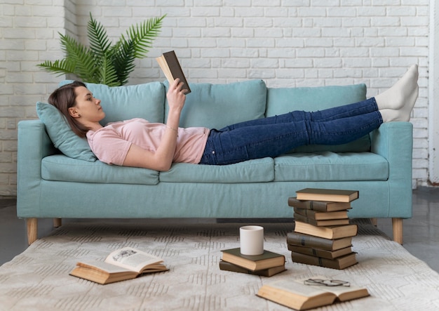 Premium Photo | Full shot woman reading on couch