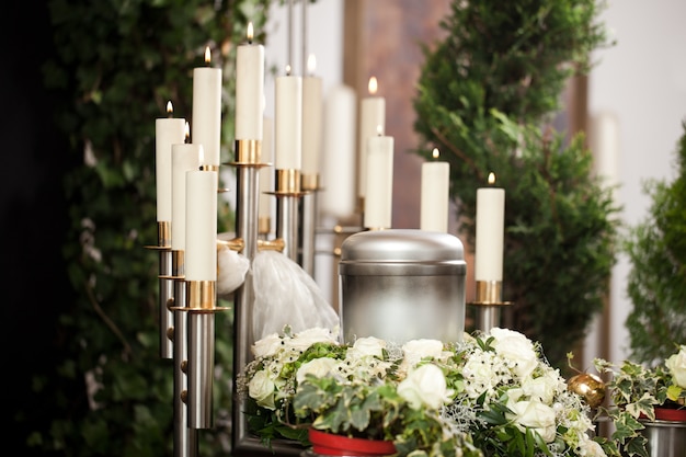 Premium Photo Funeral Urn With Candles And Flowers