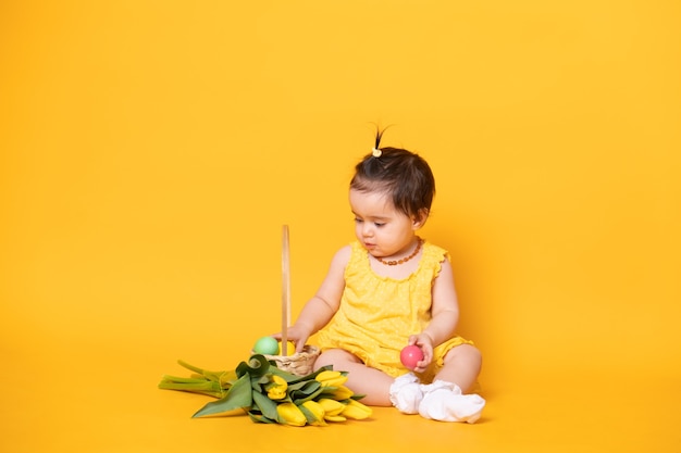 baby in yellow dress