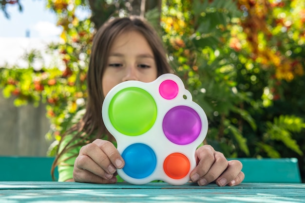 Premium Photo | A funny girl is hiding behind a toy. portrait little ...