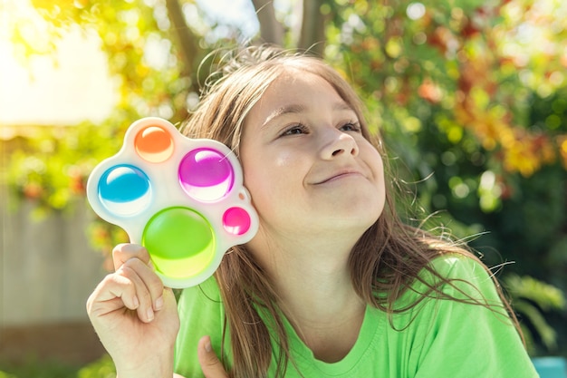 Premium Photo | A funny girl is hiding behind a toy. portrait little ...