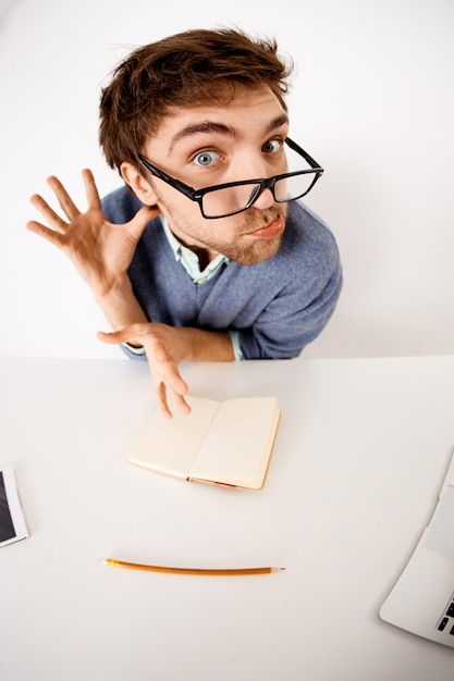 Free Photo Funny Grimacing Bearded Man In Glasses Sit Office Desk